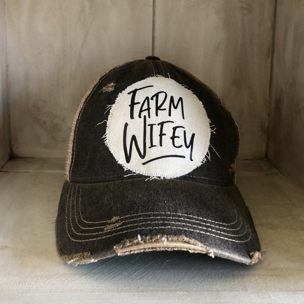 Farm Wifey hat by BohoGroove with black Farm Wifey lettering on a distressed off-white patch on a black vintage distressed snapback.