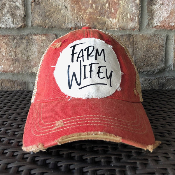 Farm Wifey hat by BohoGroove with black Farm Wifey lettering on a distressed off-white patch on a red vintage distressed snapback.