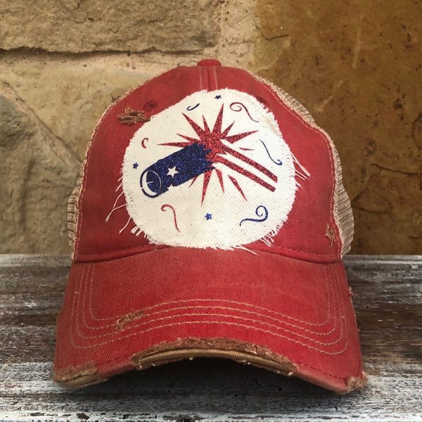 Firework hat by BohoGroove featuring blue glitter firework cannon, red firework burst, and patriotic stars on distressed off-white patch and red vintage distressed snapback