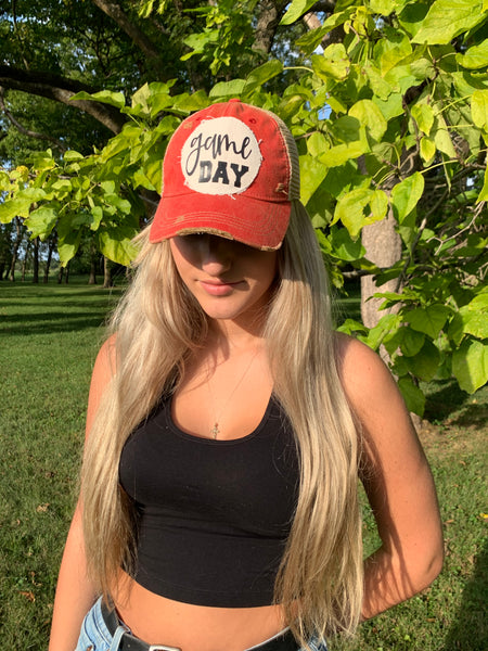 Girl wearing a red BohoGroove game day hat