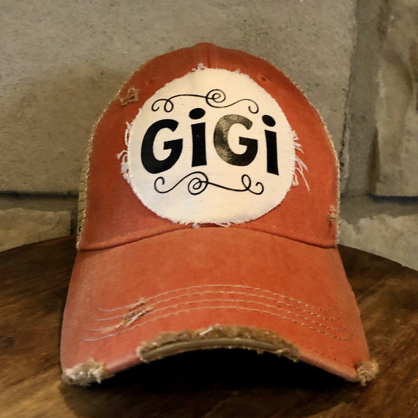 Gigi Hat by BohoGroove with black Gigi lettering on distressed off-white patch on an orange vintage distressed snapback