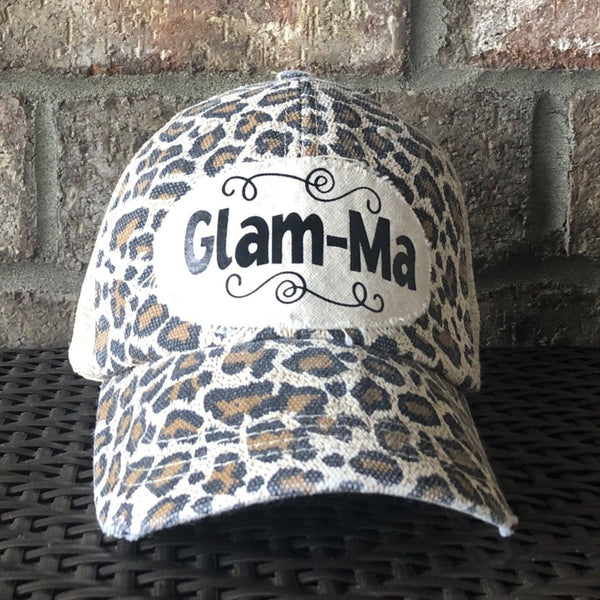 Glam-Ma hat by BohoGroove with black Glam-Ma lettering on distressed off-white patch on a leopard vintage distressed snapback.
