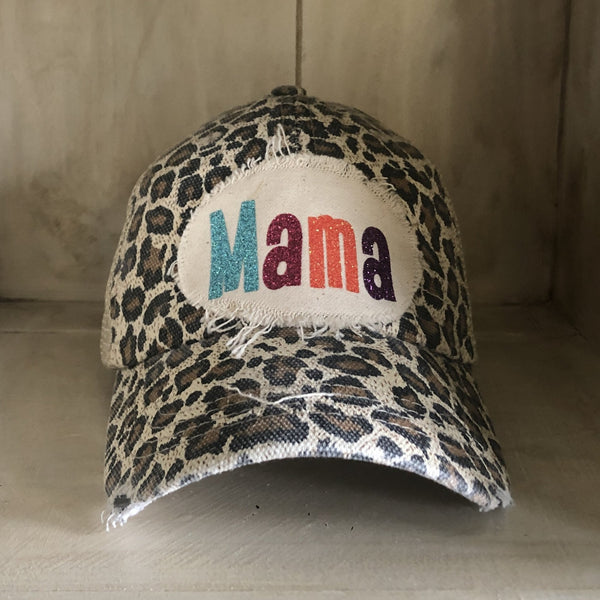 Mama Hat by BohoGroove with turquoise, pink, orange, and purple glitter Mama lettering on distressed off-white patch on a leopard vintage distressed snapback