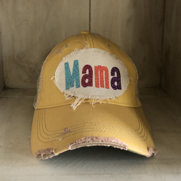 Mama Hat by BohoGroove with turquoise, pink, orange, and purple glitter Mama lettering on distressed off-white patch on a yellow vintage distressed snapback