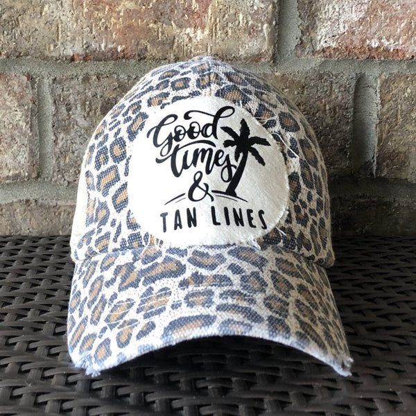 Good Times & Tan Lines hat by BohoGroove with black lettering and palm tree graphic on distressed off-white patch on leopard vintage distressed snapback.