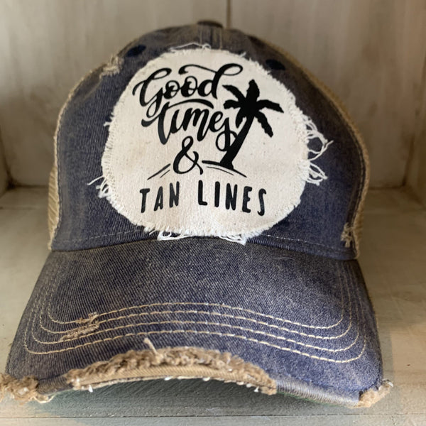Good Times & Tan Lines hat by BohoGroove with black lettering and palm tree graphic on distressed off-white patch on navy vintage distressed snapback.