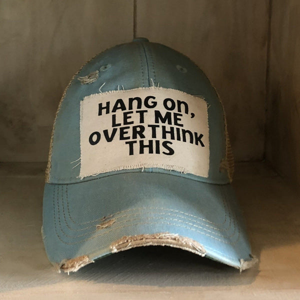 Hang On Let Me Overthink This hat by BohoGroove with black Hang On Let Me Overthink This lettering on a distressed off-white patch on an ocean blue vintage distressed snapback trucker hat.