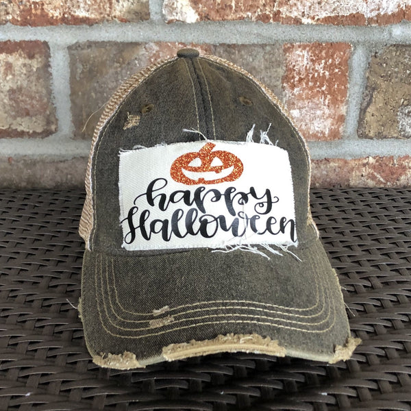 Happy Halloween hat by BohoGroove with black Happy Halloween lettering and orange glitter jack-o'-lantern graphic on a distressed off-white patch on a black vintage distressed snapback.