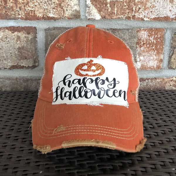 Happy Halloween hat by BohoGroove with black Happy Halloween lettering and orange glitter jack-o'-lantern graphic on a distressed off-white patch on an orange vintage distressed snapback.