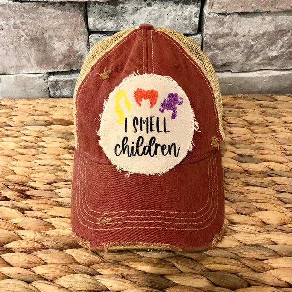 Hocus Pocus Glitter I Smell Children hat by BohoGroove with glitter witch silhouettes and I Smell Children wording on a distressed off-white patch on a brick red vintage distressed snapback.