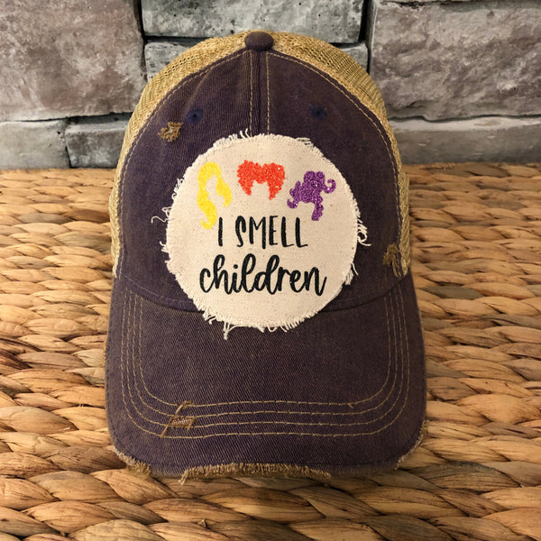Hocus Pocus Glitter I Smell Children hat by BohoGroove with yellow, orange and purple glitter witch silhouettes and I Smell Children wording on a distressed off-white patch on a purple vintage distressed snapback.