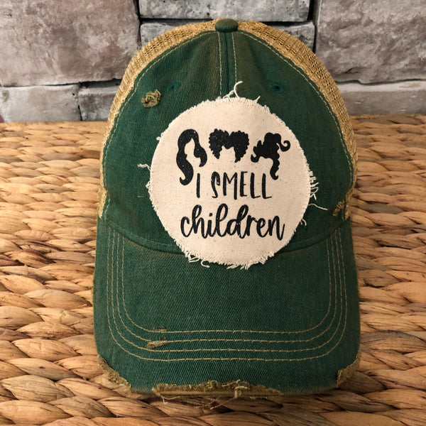 Hocus Pocus I Smell Children hat by BohoGroove with black witch silhouette graphic and I Smell Children wording on a distressed off-white patch on a camo vintage distressed snapback.