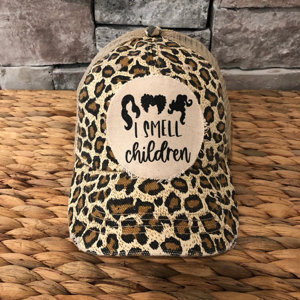 Hocus Pocus I Smell Children hat by BohoGroove with black witch silhouette graphic and I Smell Children wording on a distressed off-white patch on a leopard vintage distressed snapback.