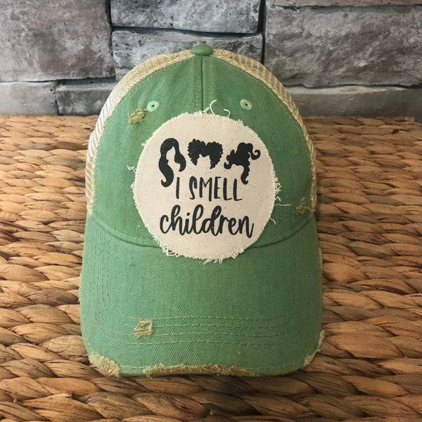Hocus Pocus I Smell Children hat by BohoGroove with black witch silhouette graphic and I Smell Children wording on a distressed off-white patch on a mint vintage distressed snapback.