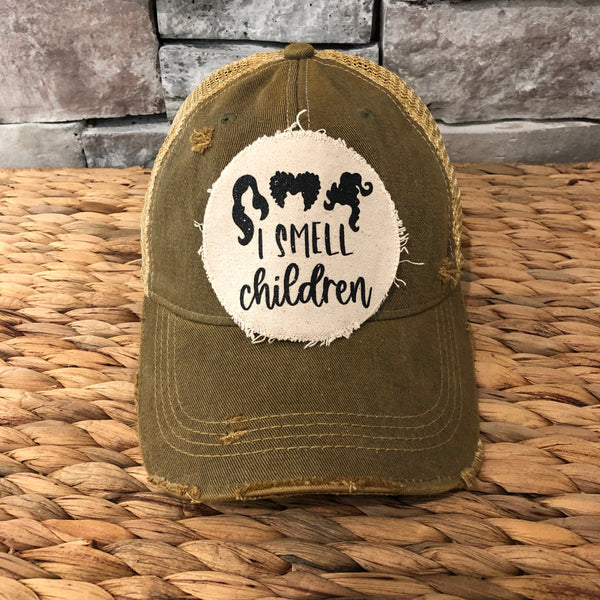 Hocus Pocus I Smell Children hat by BohoGroove with black witch silhouette graphic and I Smell Children wording on a distressed off-white patch on an olive vintage distressed snapback.