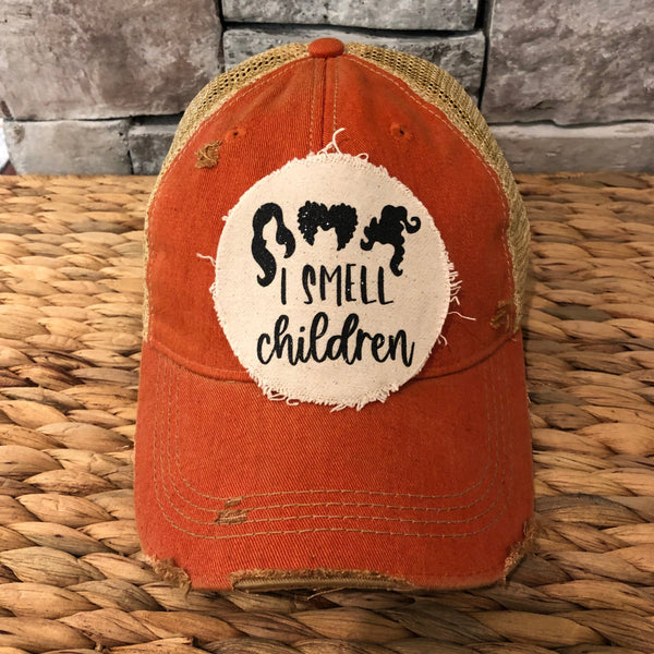 Hocus Pocus I Smell Children hat by BohoGroove with black witch silhouette graphic and I Smell Children wording on a distressed off-white patch on an orange vintage distressed snapback.