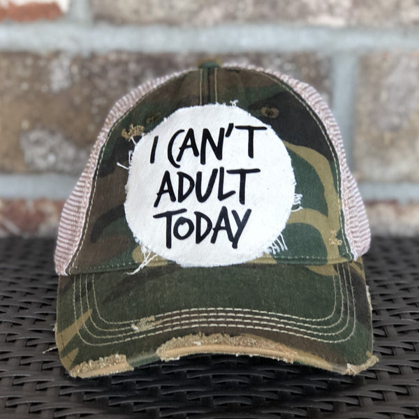 I Can't Adult Today hat by BohoGroove with black lettering on a distressed off-white patch on a camo vintage distressed snapback trucker hat.
