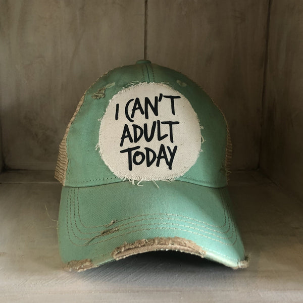 I Can't Adult Today hat by BohoGroove with black lettering on a distressed off-white patch on a mint vintage distressed snapback trucker hat.