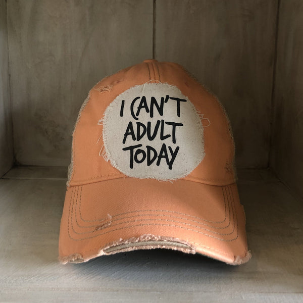I Can't Adult Today hat by BohoGroove with black lettering on a distressed off-white patch on a sherbet vintage distressed snapback trucker hat.