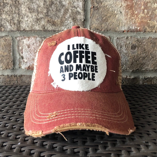 I Like Coffee and Maybe 3 People hat by BohoGroove with black lettering on a distressed off-white patch on a brick red vintage distressed snapback trucker hat.