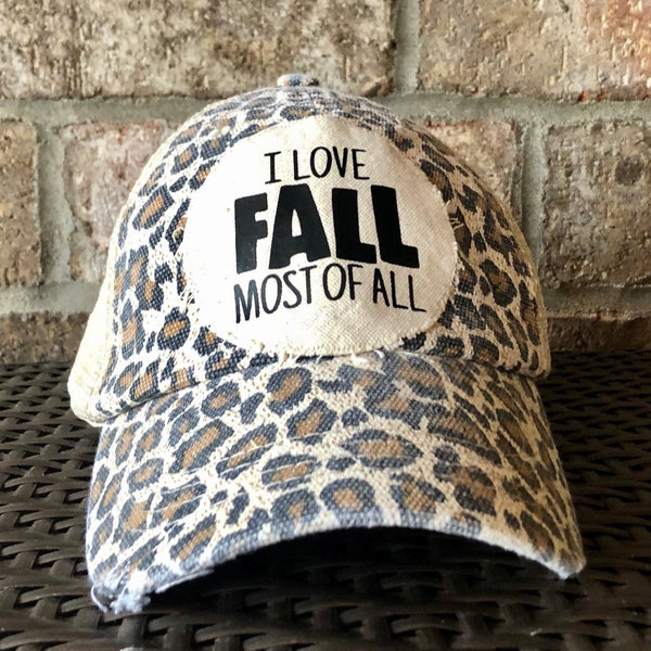 I Love Fall Most of All hat by BohoGroove with black I Love Fall Most of All lettering on a cream patch on a leopard vintage distressed snapback.