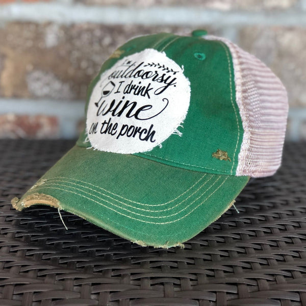 Right side view of a green vintage distressed snapback trucker hat by BohoGroove featuring a distressed off-white patch with black I'm Outdoorsy I Drink Wine on the Porch lettering and wine glass graphic.