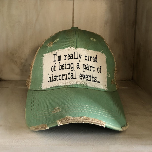 I’m Really Tired of Being Part of Historical Events hat by BohoGroove with black lettering on a distressed off-white patch on a mint vintage distressed snapback.