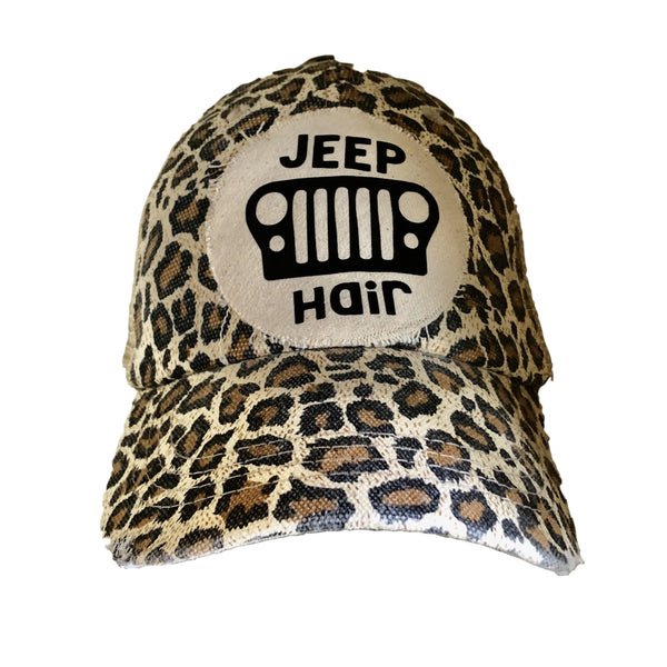 Jeep Hair hat by BohoGroove with black Jeep Hair lettering and Jeep grille graphic on a distressed off-white patch on a leopard vintage distressed snapback.
