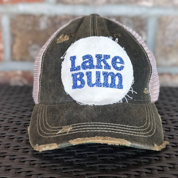 Lake Bum hat by BohoGroove with blue glitter Lake Bum lettering on distressed off-white patch on a black vintage distressed snapback.