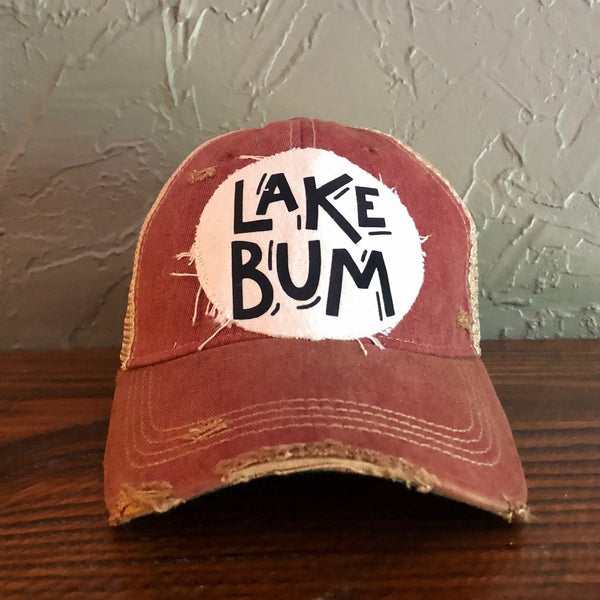 Lake Bum hat by BohoGroove with black Lake Bum lettering on distressed off-white patch on a brick red vintage distressed snapback.