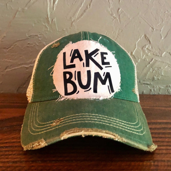 Lake Bum hat by BohoGroove with black Lake Bum lettering on distressed off-white patch on a green vintage distressed snapback.