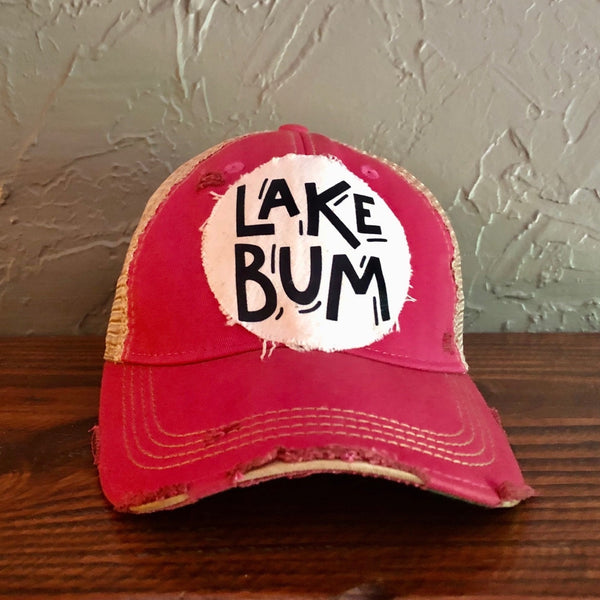 Lake Bum hat by BohoGroove with black Lake Bum lettering on distressed off-white patch on a pink vintage distressed snapback.