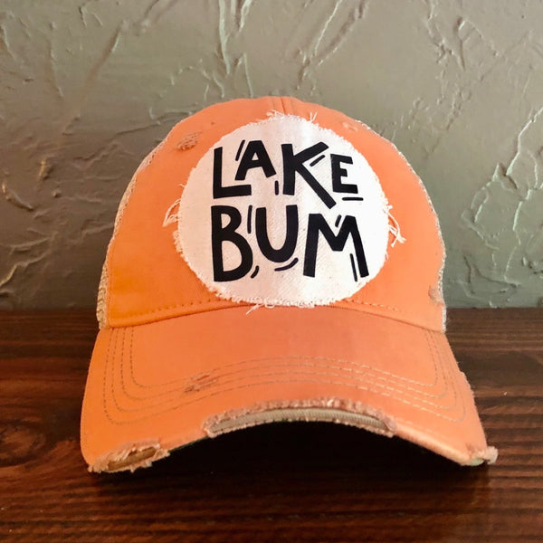 Lake Bum hat by BohoGroove with black Lake Bum lettering on distressed off-white patch on a sherbet vintage distressed snapback.