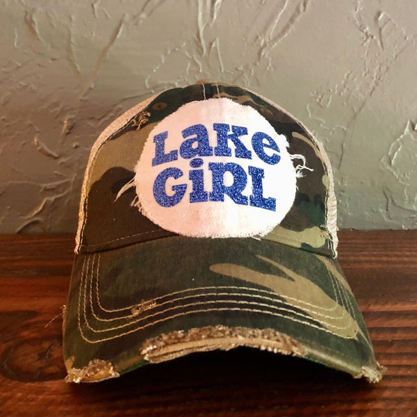 Lake Girl glitter hat by BohoGroove with blue glitter Lake Girl lettering on distressed off-white patch on a camo vintage distressed snapback.