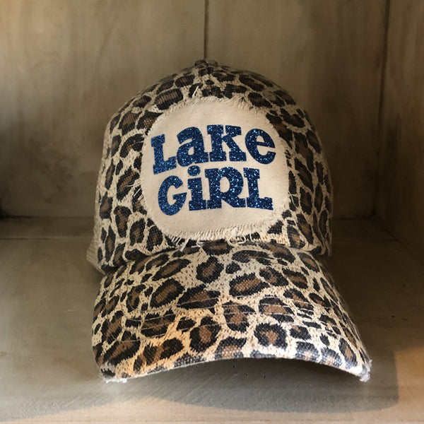 Lake Girl glitter hat by BohoGroove with blue glitter Lake Girl lettering on distressed off-white patch on a leopard vintage distressed snapback.