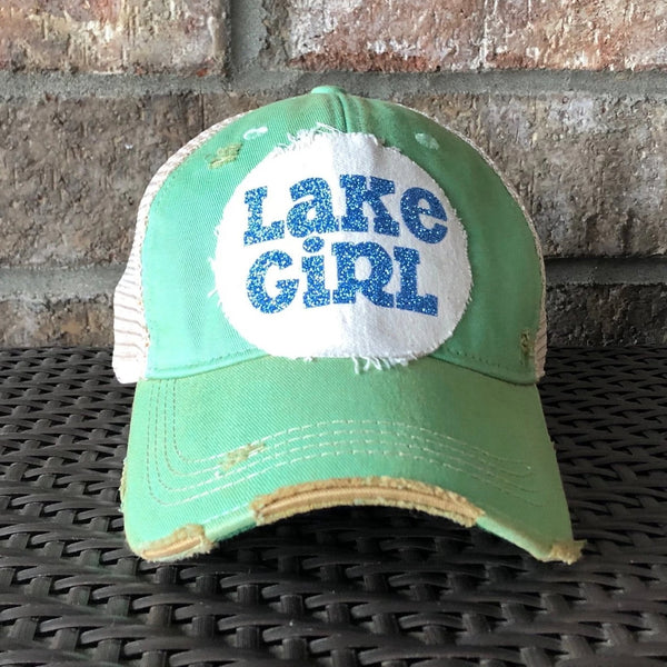 Lake Girl glitter hat by BohoGroove with blue glitter Lake Girl lettering on distressed off-white patch on a mint green vintage distressed snapback.