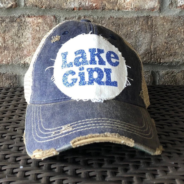Lake Girl glitter hat by BohoGroove with blue glitter Lake Girl lettering on distressed off-white patch on a navy blue vintage distressed snapback.