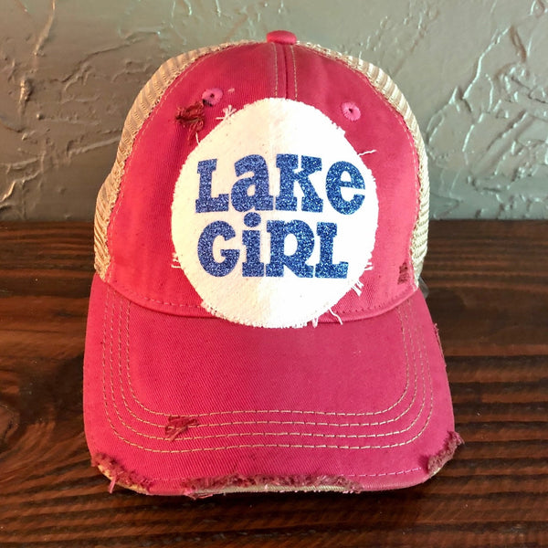 Lake Girl glitter hat by BohoGroove with blue glitter Lake Girl lettering on distressed off-white patch on a pink vintage distressed snapback.