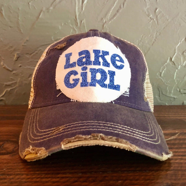 Lake Girl glitter hat by BohoGroove with blue glitter Lake Girl lettering on distressed off-white patch on a purple vintage distressed snapback.