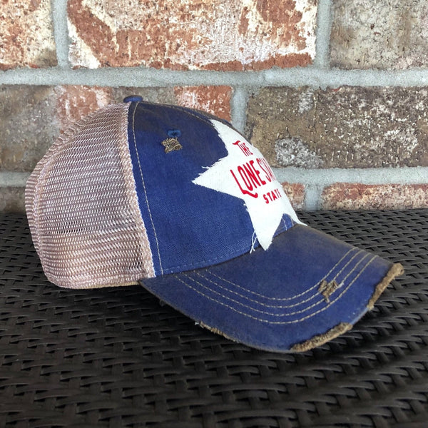 Left side view Lone Star State hat by BohoGroove with red Lone Star State lettering on white star-shaped patch and royal blue vintage distressed snapback