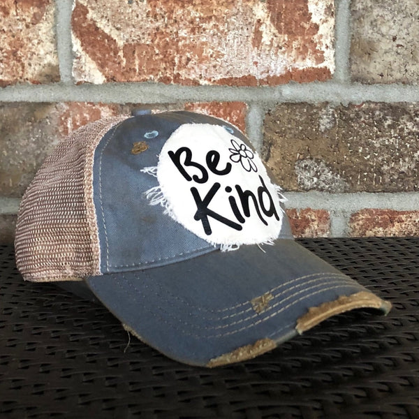Be Kind hat by BohoGroove with black Be Kind lettering and flower graphic on distressed off-white patch on light blue vintage distressed snapback.