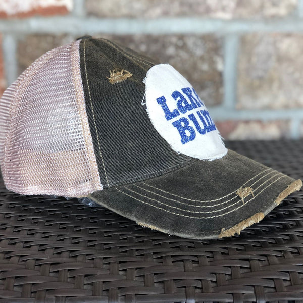 Lake Bum hat by BohoGroove with blue glitter Lake Bum lettering on distressed off-white patch on a black vintage distressed snapback left side.