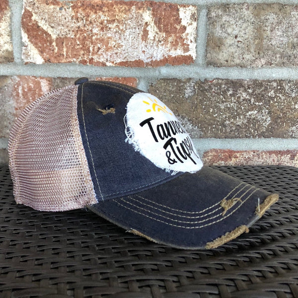 Tanned and Tipsy Hat by BohoGroove on a distressed navy snapback trucker hat with hand-applied patch design and vintage weathered style.
