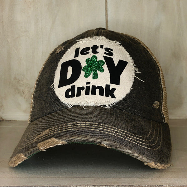 Let's Day Drink hat by BohoGroove with green lettering and shamrock graphic on a distressed off-white custom patch on a black vintage distressed snapback.