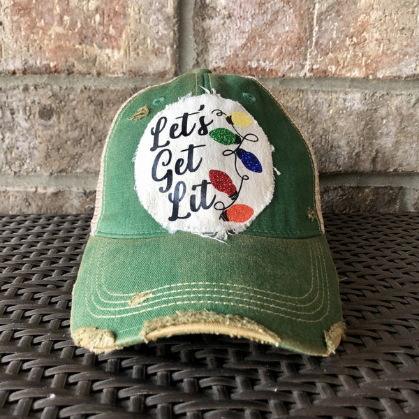Let's Get Lit hat by BohoGroove with black Let's Get Lit script lettering and multicolor glitter Christmas light graphics on a distressed off-white custom patch on a green vintage distressed snapback.
