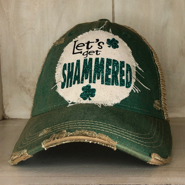Let's Get Shammered hat by BohoGroove with glitter green lettering and shamrock graphics on a distressed off-white custom patch on a green vintage distressed snapback.