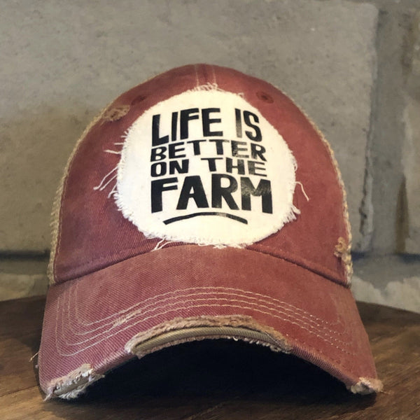 Life Is Better on the Farm hat by BohoGroove with black Life Is Better on the Farm lettering on a distressed off-white patch on a brick red vintage distressed snapback.