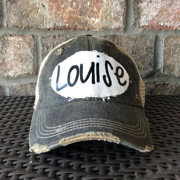 Louise hat by BohoGroove with black Louise lettering on a distressed off-white patch on a black vintage distressed snapback.