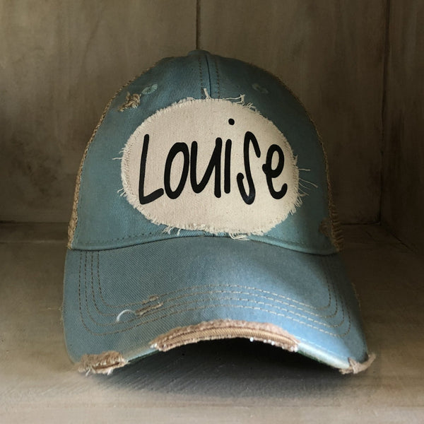 Louise hat by BohoGroove with black Louise lettering on a distressed off-white patch on a light blue vintage distressed snapback.