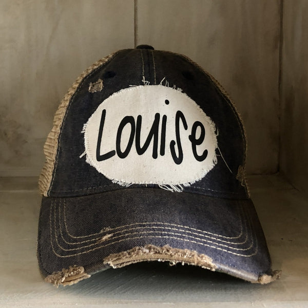 Louise hat by BohoGroove with black Louise lettering on a distressed off-white patch on a navy blue vintage distressed snapback.